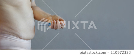 Injection Semaglutide. Blue semaglutide or insulin Injection pen and female body profile closeup Injection Semaglutide. Blue semaglutide or insulin Injection pen and female body profile closeup 110972323