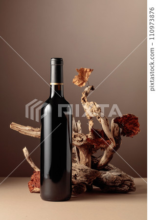 Bottle of red wine with a composition of old wood. Bottle of red wine with a composition of old wood. 110973876