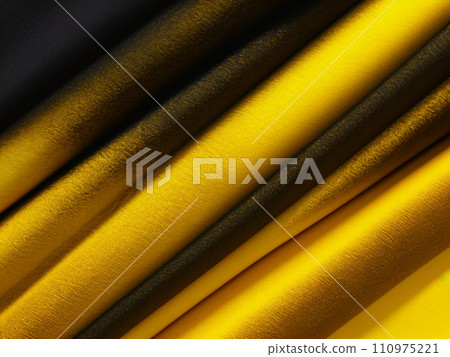 A beautiful, elegant material folded in waves or pleats. Yellow black brown fabric or paper with delicate texture and a smooth gradient. Layout for advertising or modern postcard. AI generated image 110975221