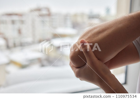 Senior man lubricating with analgetic cream his elbow. 110975534