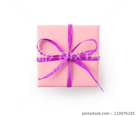 Top view of paper pink color present box with purple recycled paper ribbon isolated on white 110976185