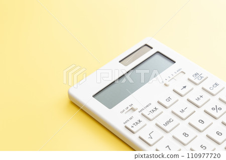 white calculator on yellow background 110977720