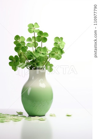 Green clover leaves in a vase isolated on white background 110977790