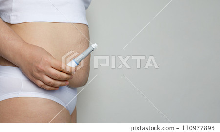 Female model showing opened Semaglutide Injection pen or insulin cartridge pen. Female model showing opened Semaglutide Injection pen or insulin cartridge pen. 110977893