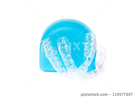 Invisible braces and blue box on white background, dental orthodontic transparent health equipment Invisible braces and blue box on white background, dental orthodontic transparent health equipment 110977897