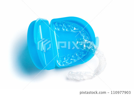 Top view of Invisible aligners for whitening and straightening of teeth with blue box Top view of Invisible aligners for whitening and straightening of teeth with blue box 110977903