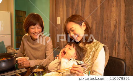 Three generation family, smiling table Three generation family, smiling table 110979891