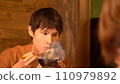 Young man eating dinner 110979892