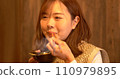 Young woman eating dinner 110979895