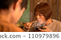 Senior woman having dinner with her parent and child 110979896