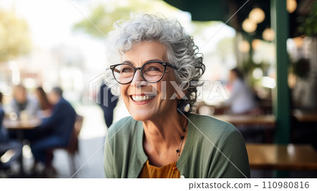 Generative AI The image shows an elderly woman with curly gray hair, wearing glasses and smiling in a cafe setting. Generative AI The image shows an elderly woman with curly gray hair, wearing glasses and smiling in a cafe setting. 110980816