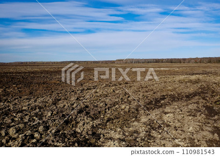 The field is freshly plowed and the sky is bright. The field is freshly plowed and the sky is bright. 110981543