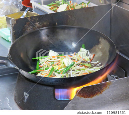 Stir-fried vegetables during cooking 110981861