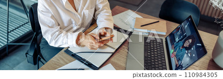 Business woman freelancer have video conference with client and use phone while sitting in cafe 110984305