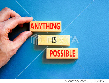 Anything is possible symbol. Concept words Anything is possible on beautiful wooden blocks. Beautiful blue table blue background. Businessman hand. Business anything possible concept. Copy space. 110984575