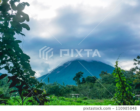Arenal volcano with its summit covered in clouds 110985848