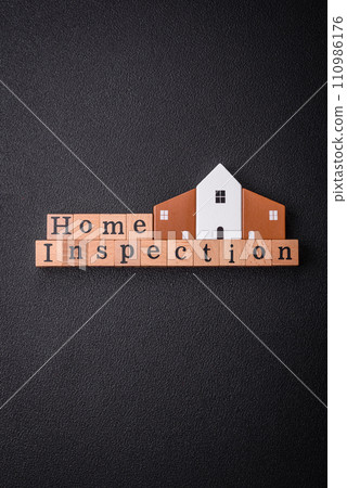 The inscription Home inspection made of wooden cubes on a plain background 110986176