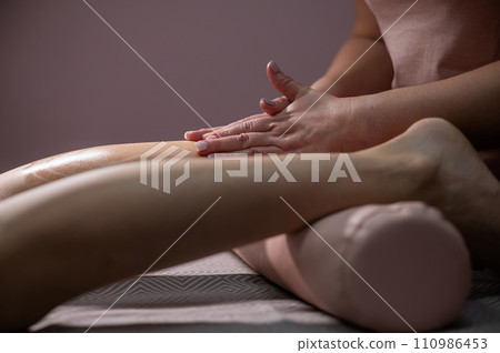 Close-up of a woman's leg massage in a salon. Close-up of a woman's leg massage in a salon. 110986453