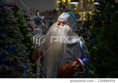 Portrait of a Russian Santa Claus in an artificial Christmas tree shop. Portrait of a Russian Santa Claus in an artificial Christmas tree shop. 110986454