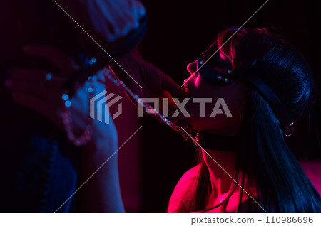 Role-playing games. Man putting finger in woman's mouth in cat mask.  110986696