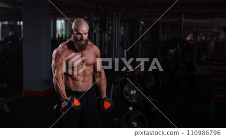 Muscular shirtless man doing exercises with dumbbells in the gym. Muscular shirtless man doing exercises with dumbbells in the gym. 110986796