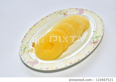 Pineapple lies in circles on a plate. Pineapple lies in circles on a plate. 110987521