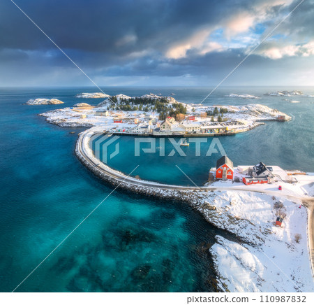 Aerial view of road, bridges, snowy islands, rorbu, sea at sunset Aerial view of road, bridges, snowy islands, rorbu, sea at sunset 110987832