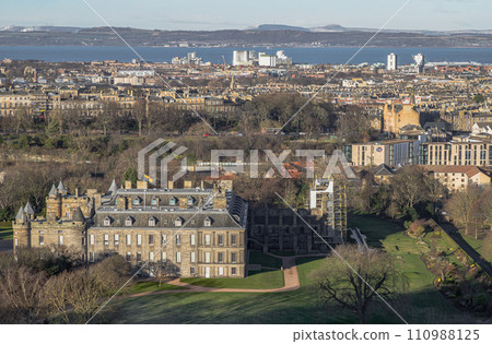 Aerial view of Palace of Holyroodhouse and Holyrood Park seen from the top of Salisbury Crags. Amazing Edinburgh Cityscape. 110988125