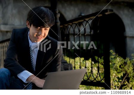 Successful businessman financier investors use laptops to communicate remotely over the internet or video call to set challenging business goals and ready to achieve targets from the outdoor hotel 110988914
