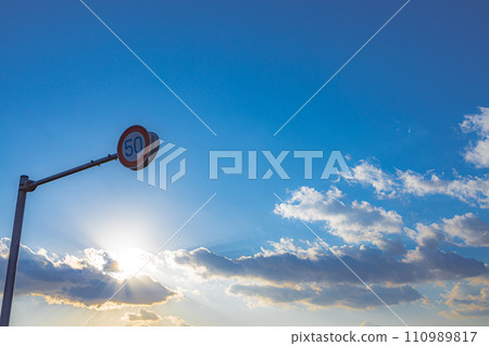 A sign standing in the morning sky 110989817