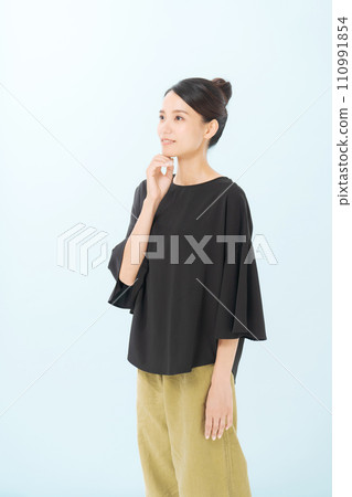 A woman in her 30s wearing a black blouse A woman in her 30s wearing a black blouse 110991854
