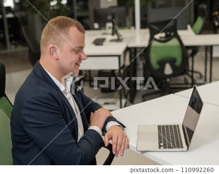 Caucasian man with hearing aid at online meeting on laptop.  110992260