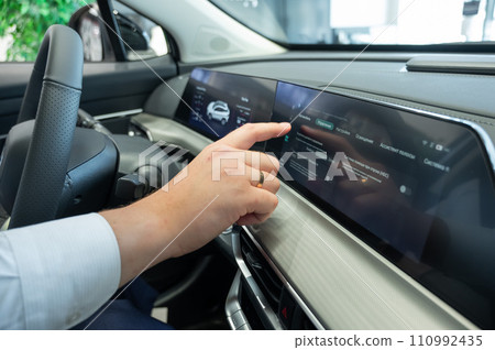 Close-up of a man's hands on the dashboard of a modern car. Close-up of a man's hands on the dashboard of a modern car. 110992435