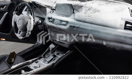 Car interior in a layer of cleaning foam. Car interior in a layer of cleaning foam. 110992822
