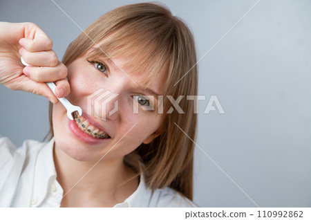 The woman jokingly tightens the wire of the brakes with a wrench. Bite correction device 110992862
