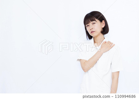 A female nurse suffering from stiff shoulders A female nurse suffering from stiff shoulders 110994686