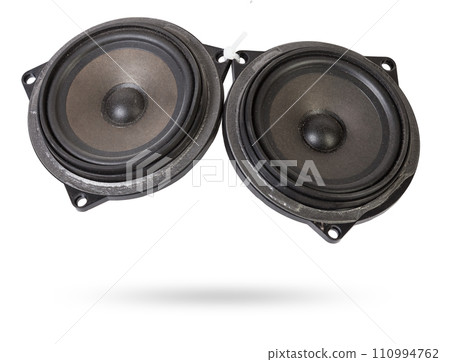 Two speakers of an acoustic system - an audio for playing music in a car interior on a white isolated background in a photo studio. Spare parts for auto repair in a workshop or for sale for tuning 110994762
