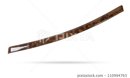 Decorative overlay of the panel and doors of the car interior from the root of the walnut tree in brown color. 110994763