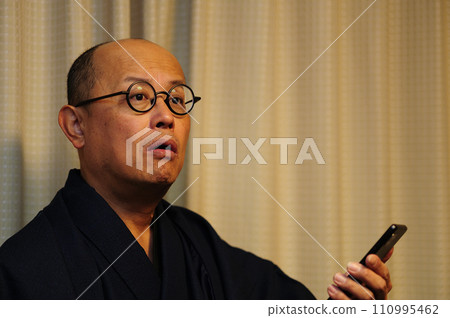Middle-aged man relaxing in Japanese clothes Middle-aged man relaxing in Japanese clothes 110995462