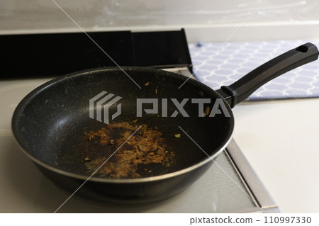 A frying pan with stubborn black marks on it A frying pan with stubborn black marks on it 110997330