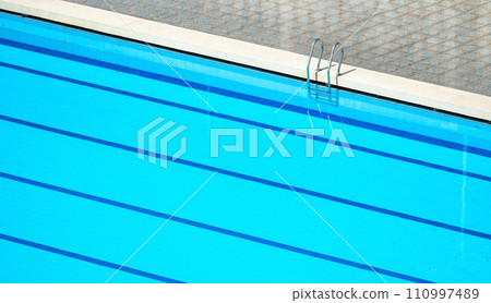 Top view swimming pool outlined by bold lanes, inviting swimmers to glide through clear turquoise water. lanes, neatly divided by marker lines, perfect for training and competition 110997489