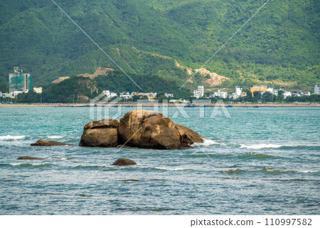 Nha Trang, Vietnam's coastal beauty unfurls in vibrant spectacle during day. stones and golden sands meet azure sea under radiant sun, creating picturesque panorama of beaches and clear waters. Nha Trang, Vietnam's coastal beauty unfurls in vibrant spectacle during day. stones and golden sands meet azure sea under radiant sun, creating picturesque panorama of beaches and clear waters. 110997582