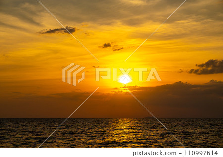 Fiery horizon, dramatic ocean sunset in vibrant hues over dark waters, nature breathtaking photo reflecting artistry of dusk's tranquil spectacle and coastal beauty Fiery horizon, dramatic ocean sunset in vibrant hues over dark waters, nature breathtaking photo reflecting artistry of dusk's tranquil spectacle and coastal beauty 110997614