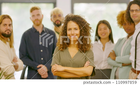 Woman leading a group of coworkers standing proud Woman leading a group of coworkers standing proud 110997859