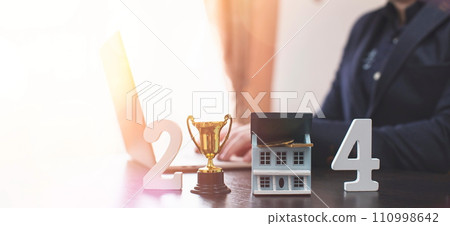 businessman buying property in 2024 using digital technology and laptop computer. Finance and trade concept 2024. Double exposure 110998642