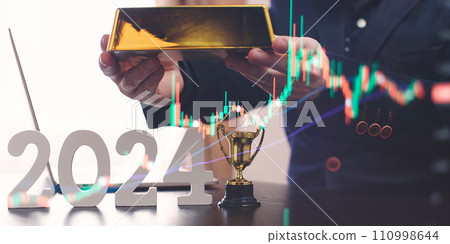 businessman buys gold using digital technology and laptop computer with forex chart and candlestick chart on screen. Finance and trade concept 2024. Double exposure 110998644