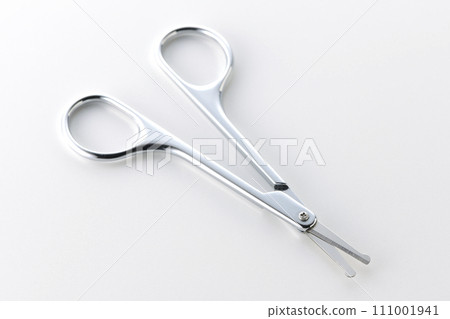 A photo of scissors cutting nose hair against a white background A photo of scissors cutting nose hair against a white background 111001941