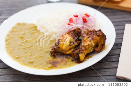 Chicken wings with mashed peas, rice and pickled onions on white plate Chicken wings with mashed peas, rice and pickled onions on white plate 111003292