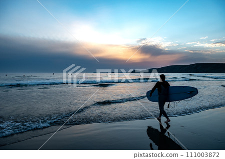 Male Surfer At Newgale Beach At The Atlantic Coast Of Pembrokeshire In Wales, United Kingdom 111003872