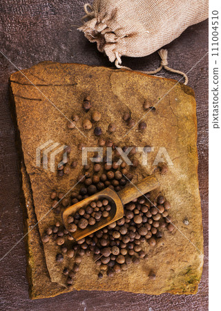 Black pepper in bow on wooden table Black pepper in bow on wooden table 111004510
